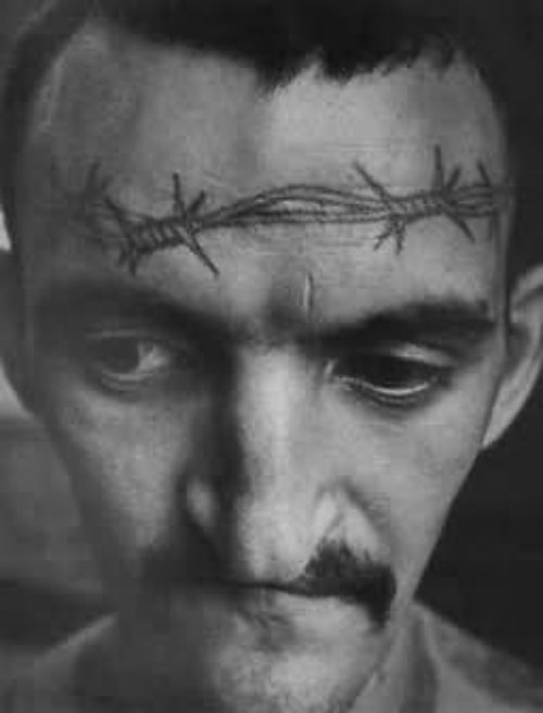 Barbed Wire Tattoo On Man Forehead